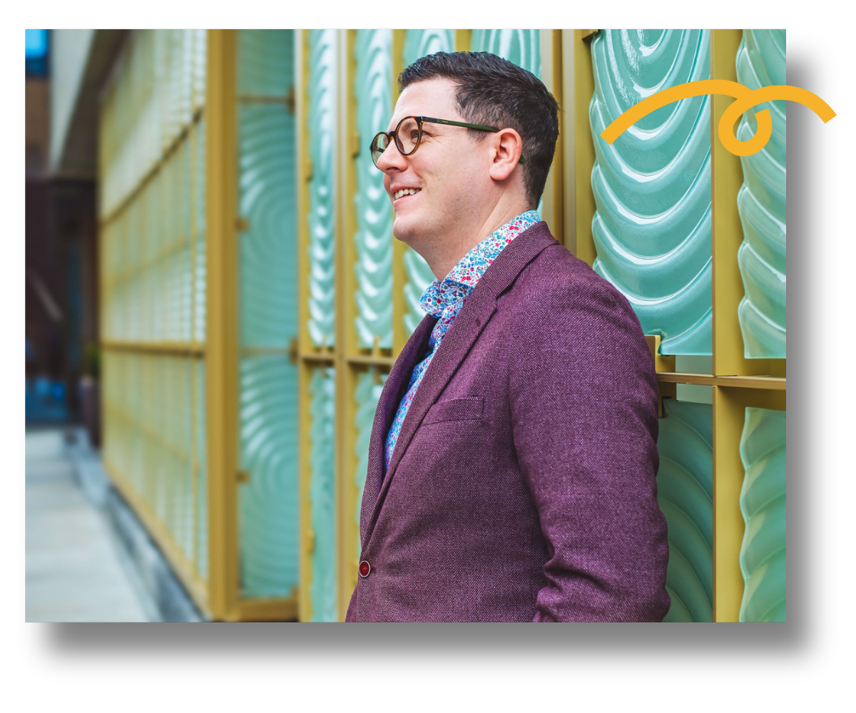 Benjamin Mayhew, advice-only financial advisor, leaning against a wall.